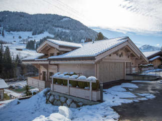 Discover the charm of this stunning chalet nestled in a snowy mountain landscape.
