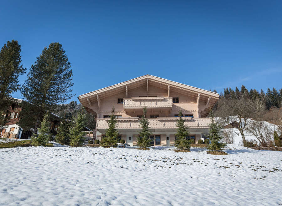 Discover the charm of this stunning wooden chalet nestled in a picturesque winter landscape.