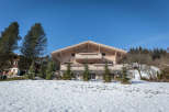 Discover the charm of this stunning wooden chalet nestled in a picturesque winter landscape.