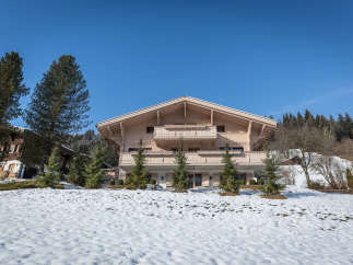 Discover the charm of this stunning wooden chalet nestled in a picturesque winter landscape.