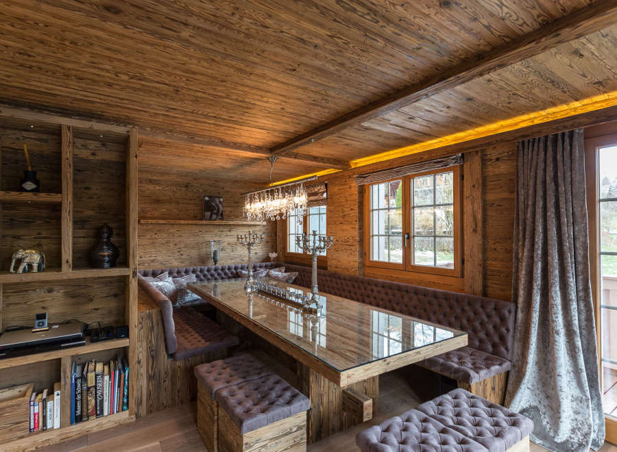 This stunning dining area features a rustic wooden design, creating a warm and inviting atmosphere.