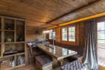 This stunning dining area features a rustic wooden design, creating a warm and inviting atmosphere.