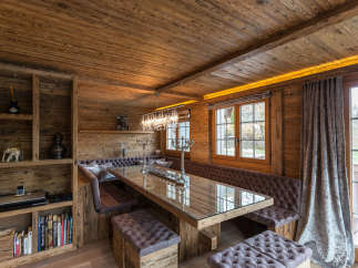 This stunning dining area features a rustic wooden design, creating a warm and inviting atmosphere.