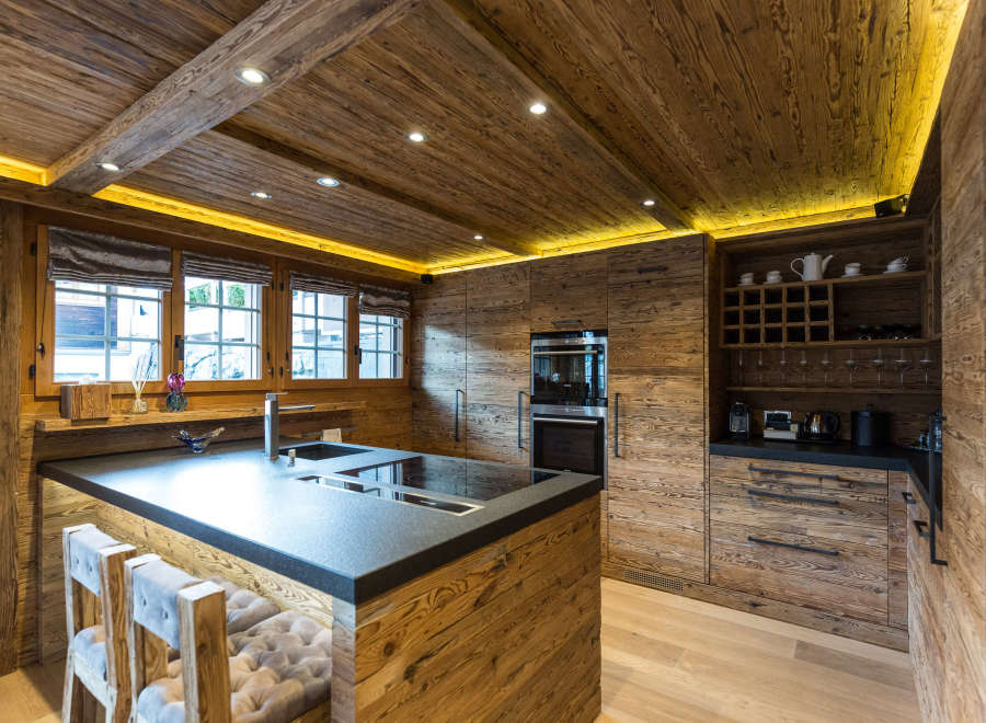 Experience rustic elegance in this stunning kitchen, featuring warm wooden accents and a sleek, modern design.