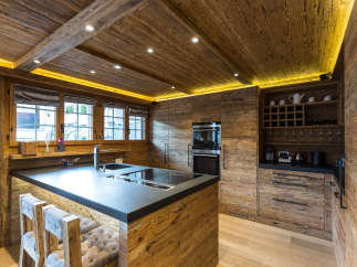 Experience rustic elegance in this stunning kitchen, featuring warm wooden accents and a sleek, modern design.