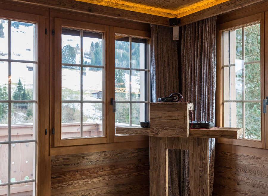 Experience rustic charm in this cozy room, featuring warm wooden walls and ceilings.