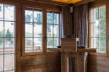 Experience rustic charm in this cozy room, featuring warm wooden walls and ceilings.