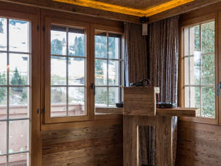 Experience rustic charm in this cozy room, featuring warm wooden walls and ceilings.