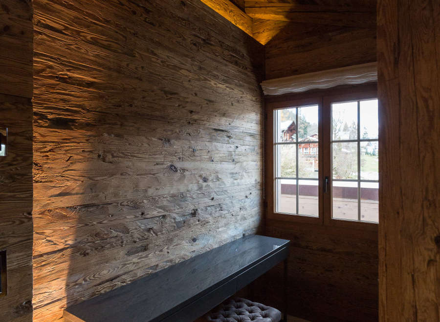 Experience rustic elegance in this stunning room, featuring exquisite wood paneling and a cozy ambiance.