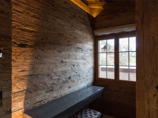 Experience rustic elegance in this stunning room, featuring exquisite wood paneling and a cozy ambiance.