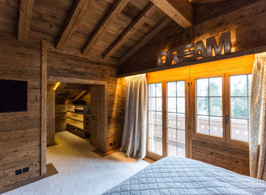 Experience the warmth of this rustic bedroom, featuring stunning wooden accents throughout.
