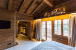 Experience the warmth of this rustic bedroom, featuring stunning wooden accents throughout.
