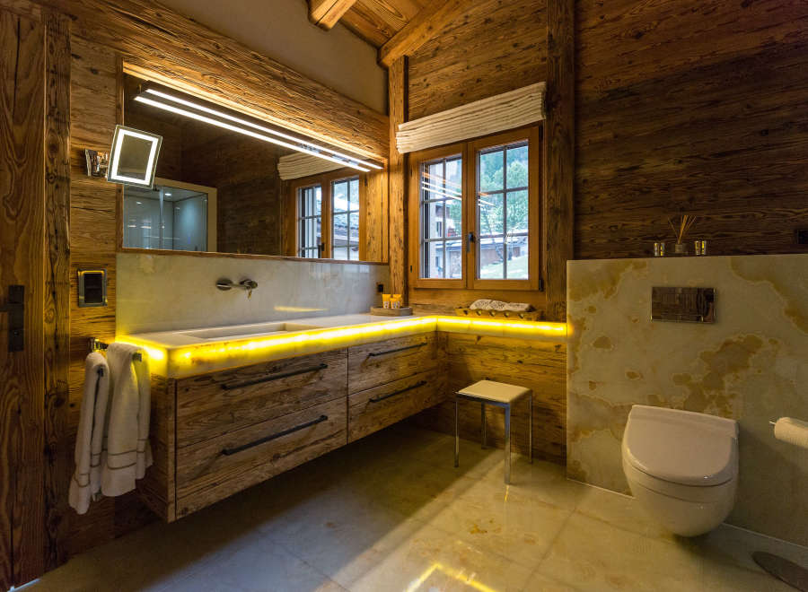 Experience luxury in this stunning bathroom featuring exquisite wooden accents and a modern design.