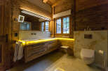 Experience luxury in this stunning bathroom featuring exquisite wooden accents and a modern design.