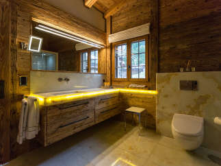 Experience luxury in this stunning bathroom featuring exquisite wooden accents and a modern design.