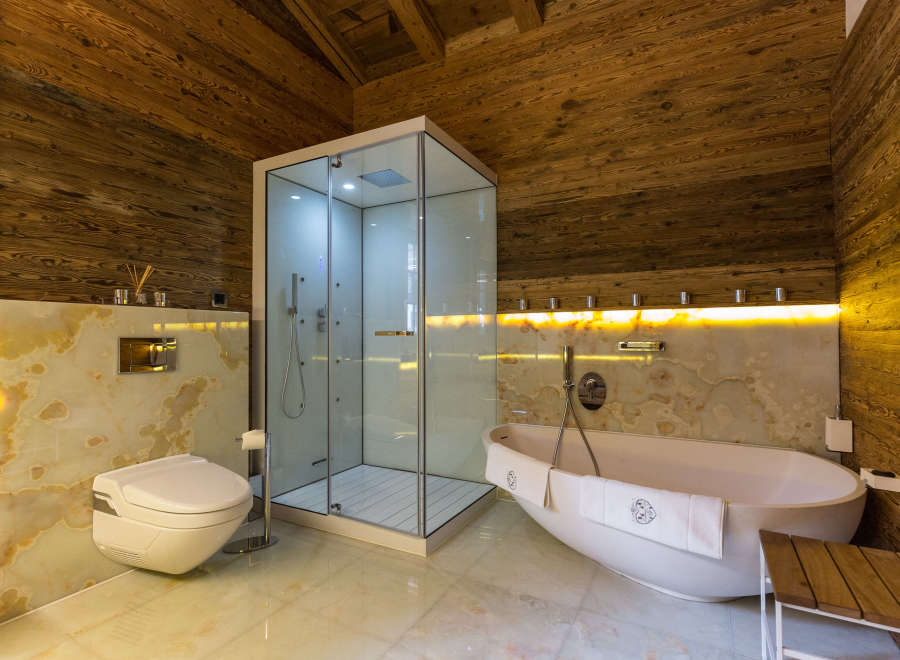 Experience luxury in this stunning bathroom featuring a modern shower and a relaxing bathtub.