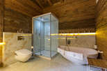 Experience luxury in this stunning bathroom featuring a modern shower and a relaxing bathtub.