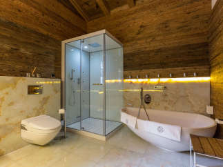 Experience luxury in this stunning bathroom featuring a modern shower and a relaxing bathtub.