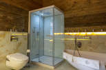 Experience luxury in this stunning bathroom featuring a modern shower and a relaxing bathtub.