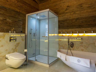 Experience luxury in this stunning bathroom featuring a modern shower and a relaxing bathtub.