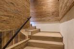 This stunning interior showcases a beautifully crafted wooden staircase, complemented by matching wooden walls and ceiling.