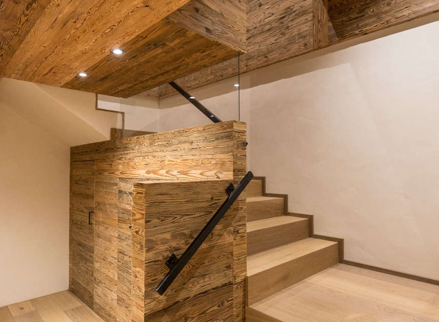 This stunning interior showcases a beautiful wooden staircase and ceiling, creating a warm and inviting atmosphere.