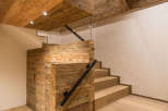 This stunning interior showcases a beautiful wooden staircase and ceiling, creating a warm and inviting atmosphere.