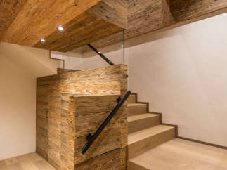 This stunning interior showcases a beautiful wooden staircase and ceiling, creating a warm and inviting atmosphere.