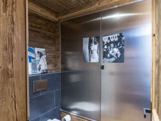 This luxurious bathroom features a unique blend of rustic and modern design elements.