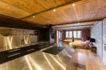 This stunning kitchen boasts a rustic charm with its wooden ceiling and walls, creating a warm and inviting atmosphere.