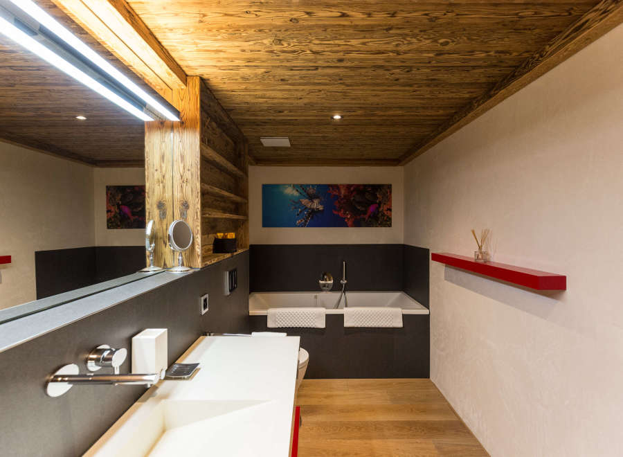 Experience luxury in this stunning bathroom featuring a unique wooden ceiling and walls.