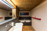 Experience luxury in this stunning bathroom featuring a unique wooden ceiling and walls.