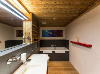 Experience luxury in this stunning bathroom featuring a unique wooden ceiling and walls.