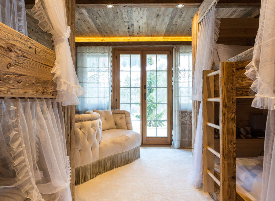 Step into a cozy and inviting bedroom with rustic wooden bunk beds, perfect for a family getaway.