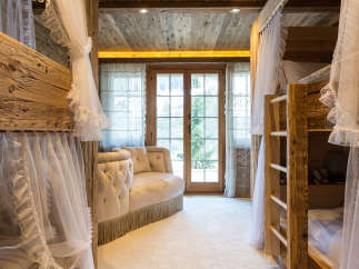 Step into a cozy and inviting bedroom with rustic wooden bunk beds, perfect for a family getaway.