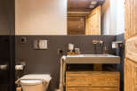 This stunning bathroom boasts a rustic charm with its wooden ceiling and cabinetry.
