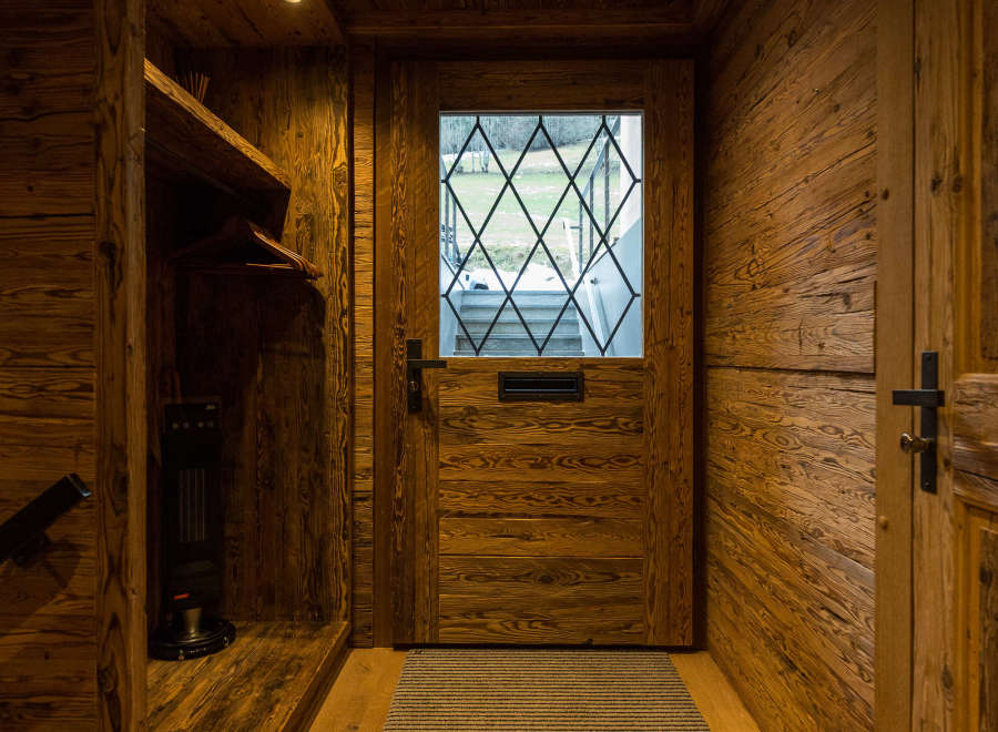 Step into rustic elegance with this stunning wooden entryway.