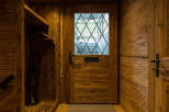 Step into rustic elegance with this stunning wooden entryway.