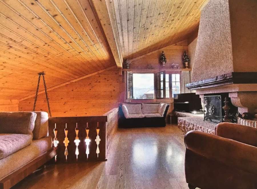 This stunning property boasts a cozy interior with a wooden ceiling and walls, creating a warm and inviting atmosphere.