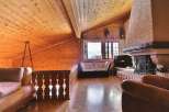 This stunning property boasts a cozy interior with a wooden ceiling and walls, creating a warm and inviting atmosphere.