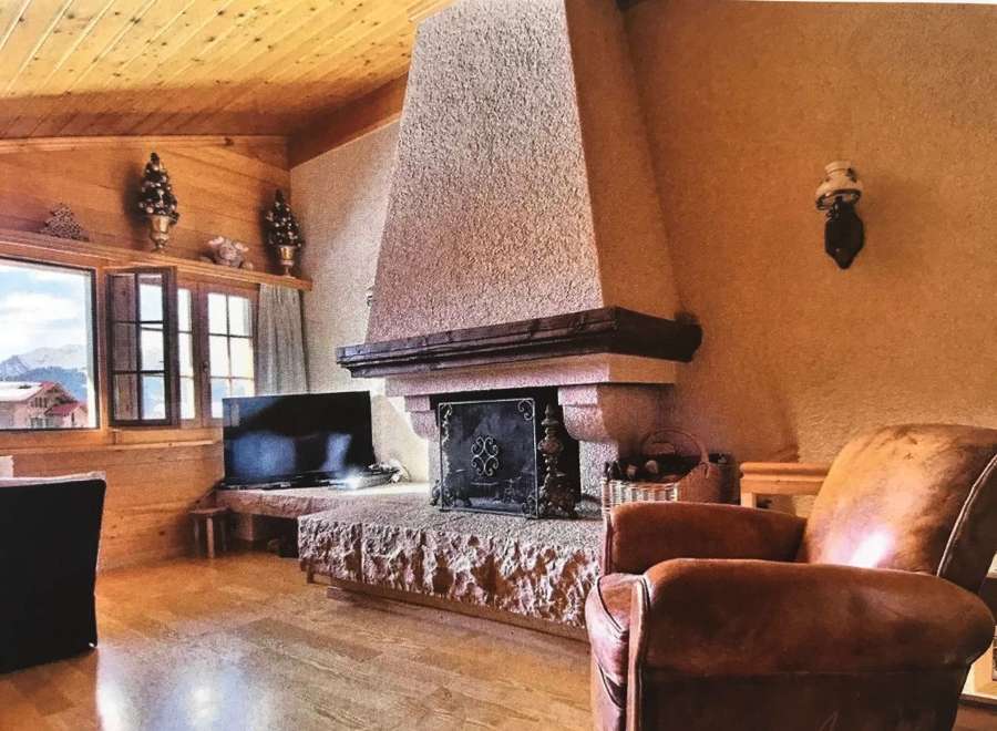 Cozy living room with a rustic fireplace, perfect for relaxing evenings.