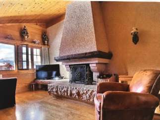 Cozy living room with a rustic fireplace, perfect for relaxing evenings.