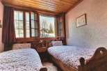 Cozy bedroom with two single beds, perfect for a relaxing getaway.