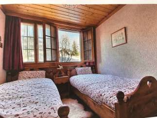 Cozy bedroom with two single beds, perfect for a relaxing getaway.