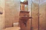 This bathroom features a unique design with tiled walls and a vintage aesthetic.