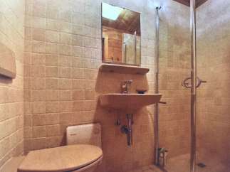 This bathroom features a unique design with tiled walls and a vintage aesthetic.