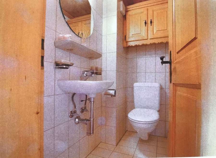 This charming bathroom features a classic design with a touch of rustic elegance.