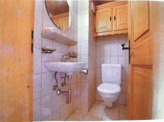 This charming bathroom features a classic design with a touch of rustic elegance.