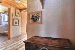 Step into a charming home with a rustic wooden floor and ceiling, creating a warm and inviting atmosphere.