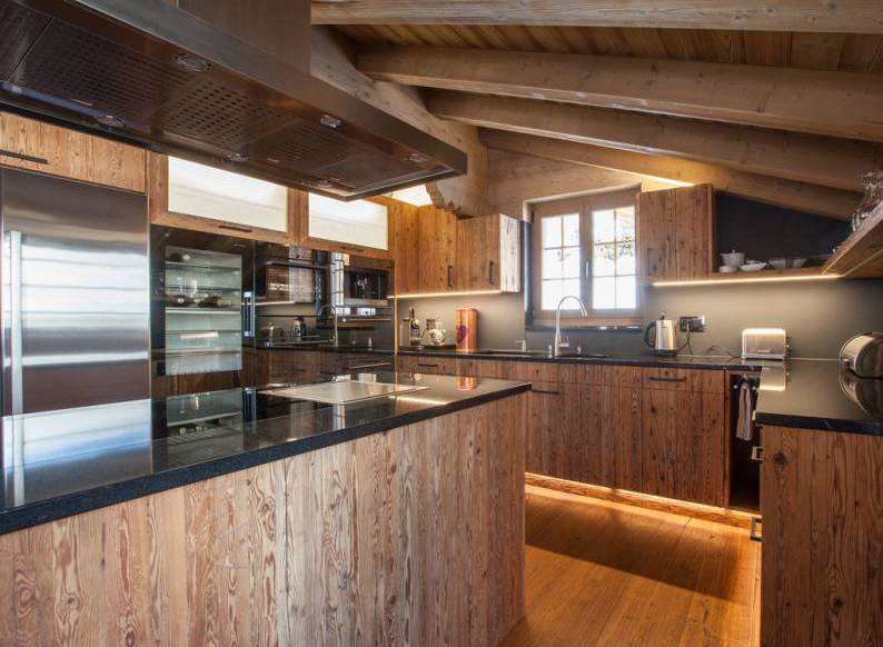 This stunning kitchen boasts a rustic charm with its wooden cabinetry and island, creating a warm and inviting atmosphere.